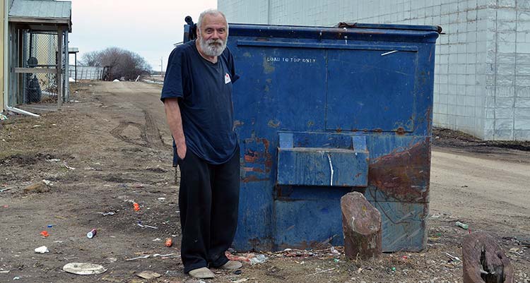 Garbage truck dumps man